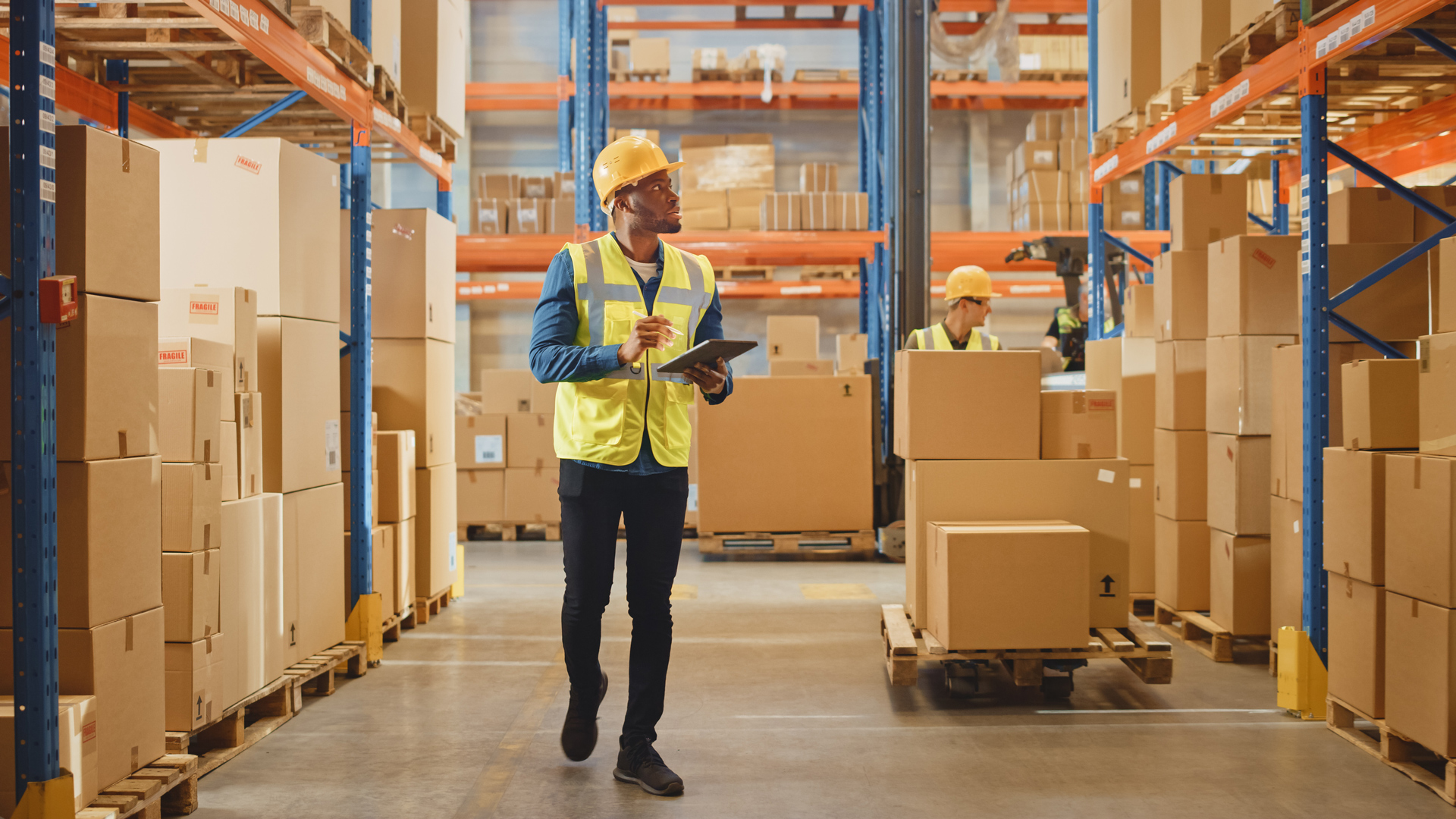 man with tablet in warehouse